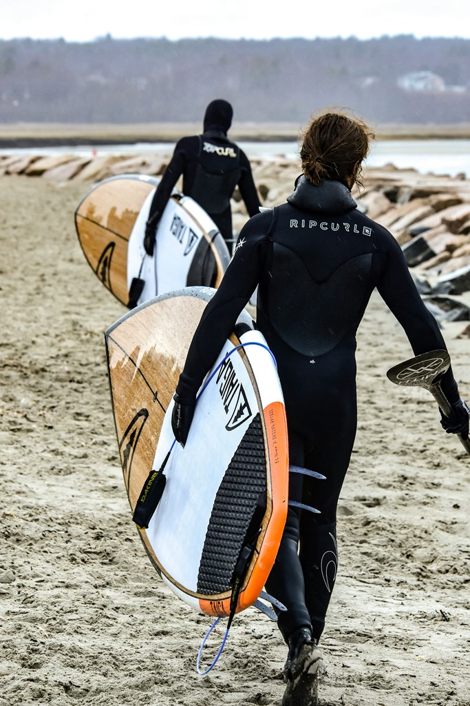 A Couple on the way to sea with paddleboards